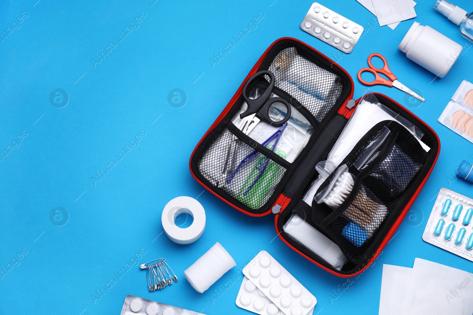 Photo of Flat lay composition with first aid kit on light blue background. Space for text