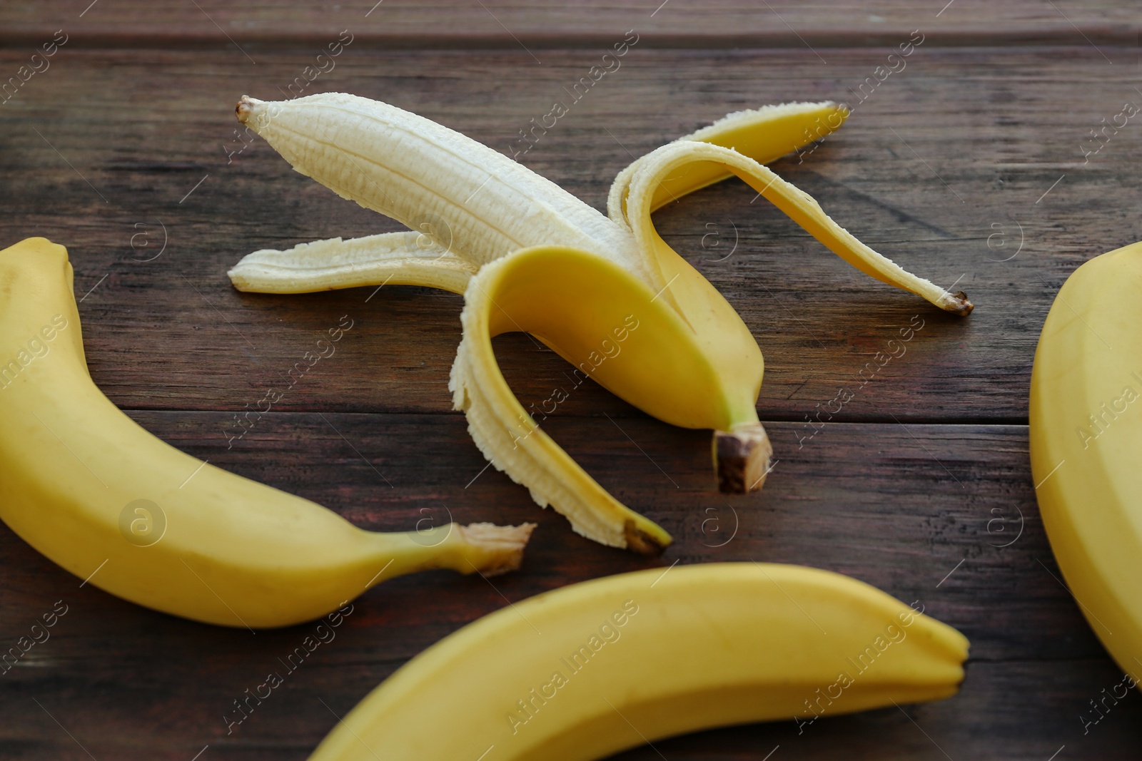 Photo of Delicious yellow bananas on wooden table, closeup