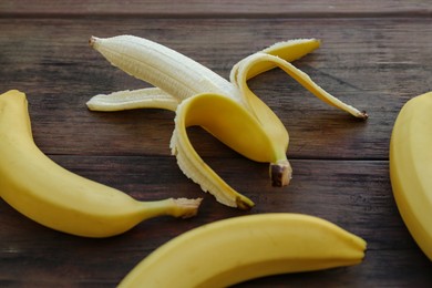 Delicious yellow bananas on wooden table, closeup