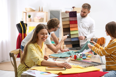 Photo of Fashion designers creating new clothes in studio