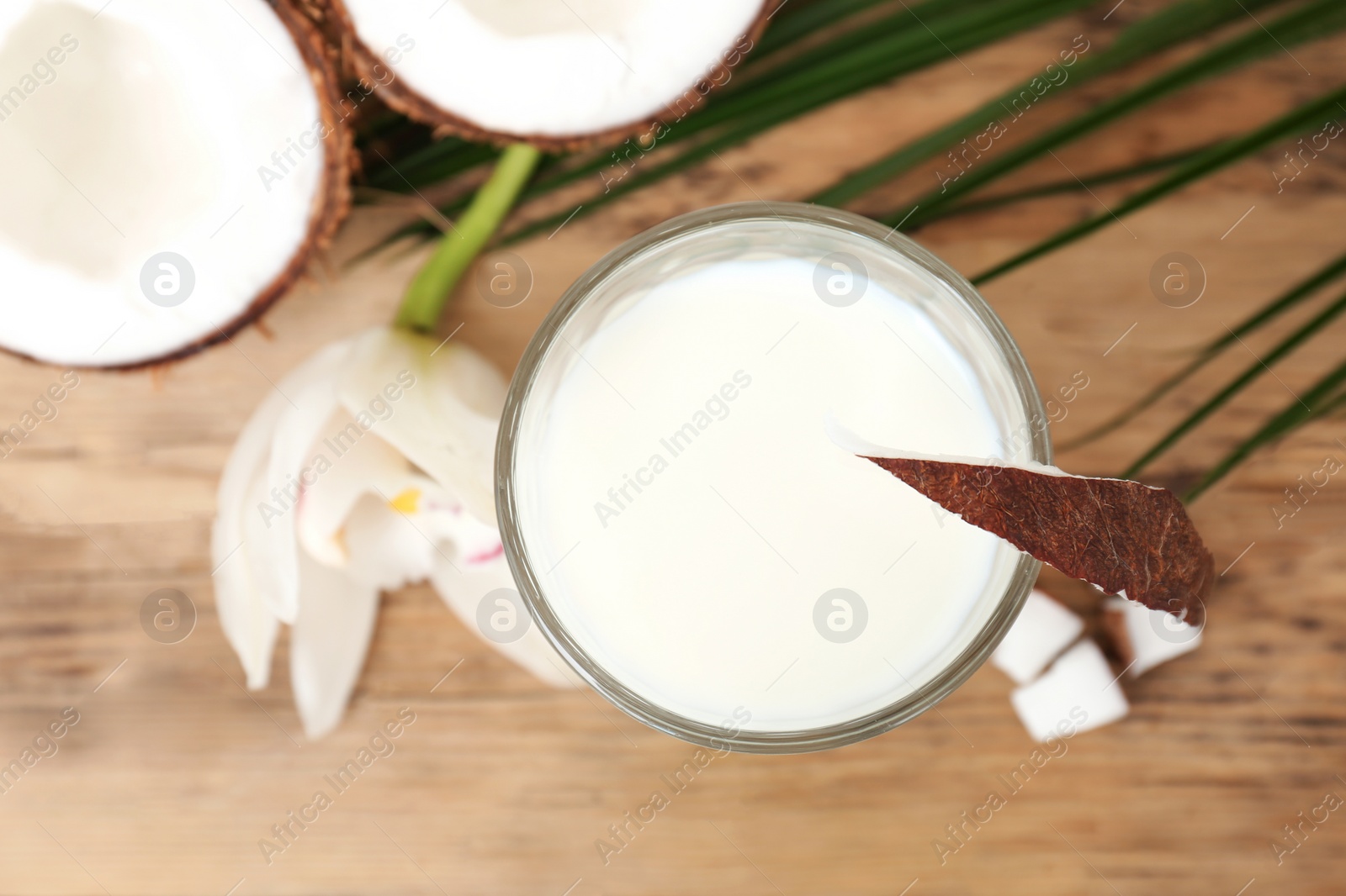 Photo of Glass of coconut milk on wooden background, closeup