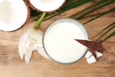 Photo of Glass of coconut milk on wooden background, closeup