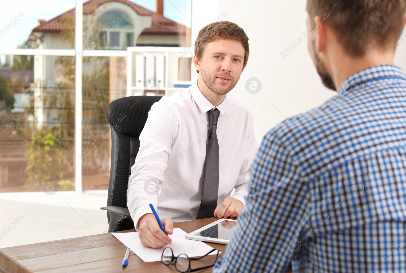 Photo of Human resources manager conducting job interview with applicant in office