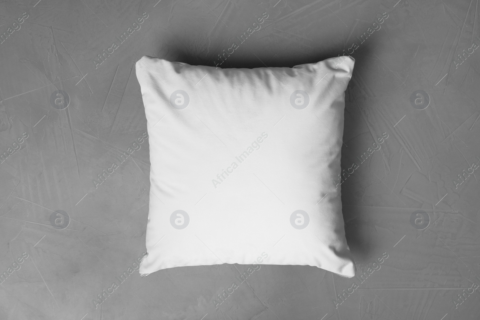Photo of Blank soft pillow on grey stone background, top view