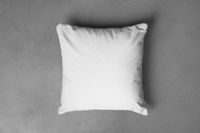 Blank soft pillow on grey stone background, top view