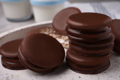 Tasty choco pies in plate, closeup view