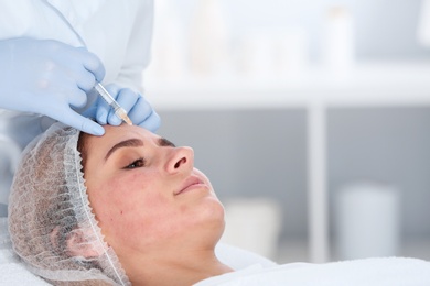 Photo of Woman undergoing face biorevitalization procedure in salon, closeup. Cosmetic treatment