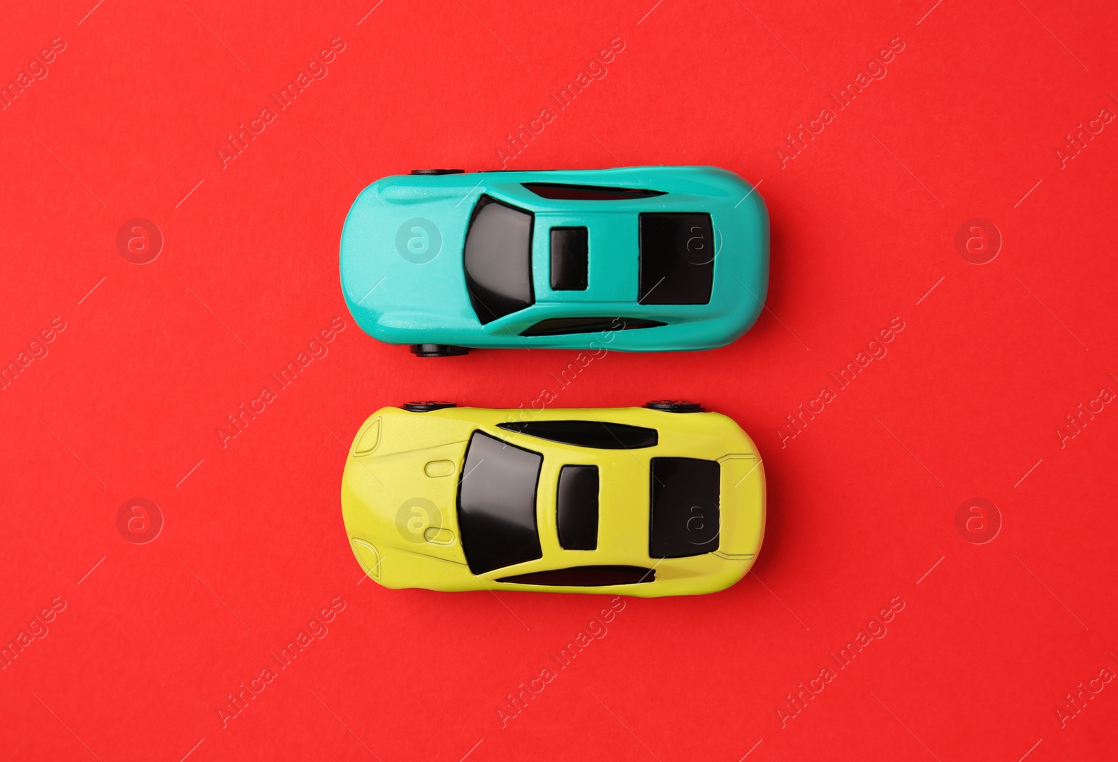 Photo of Different bright cars on red background, flat lay