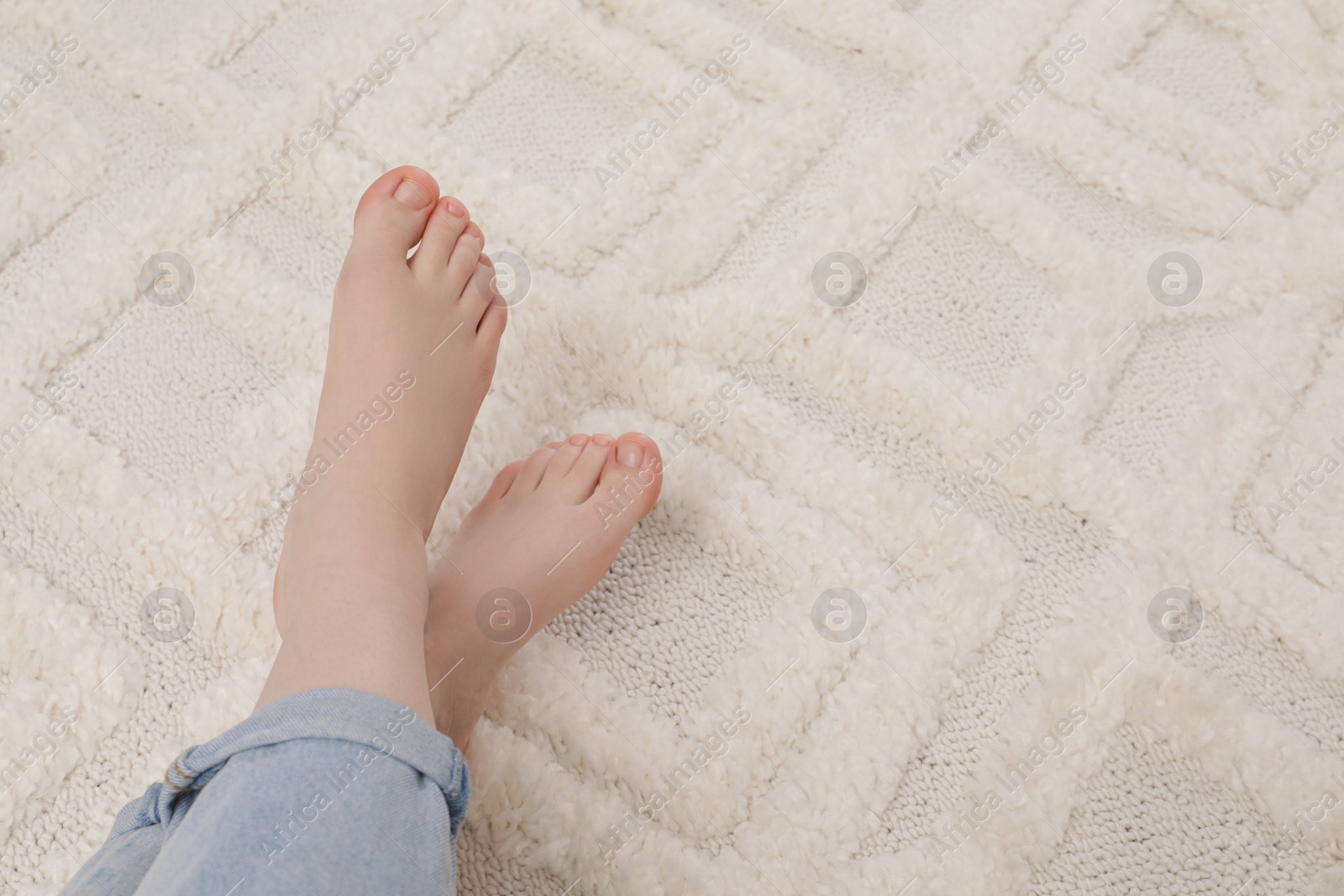 Photo of Woman on beige carpet, closeup. Space for text