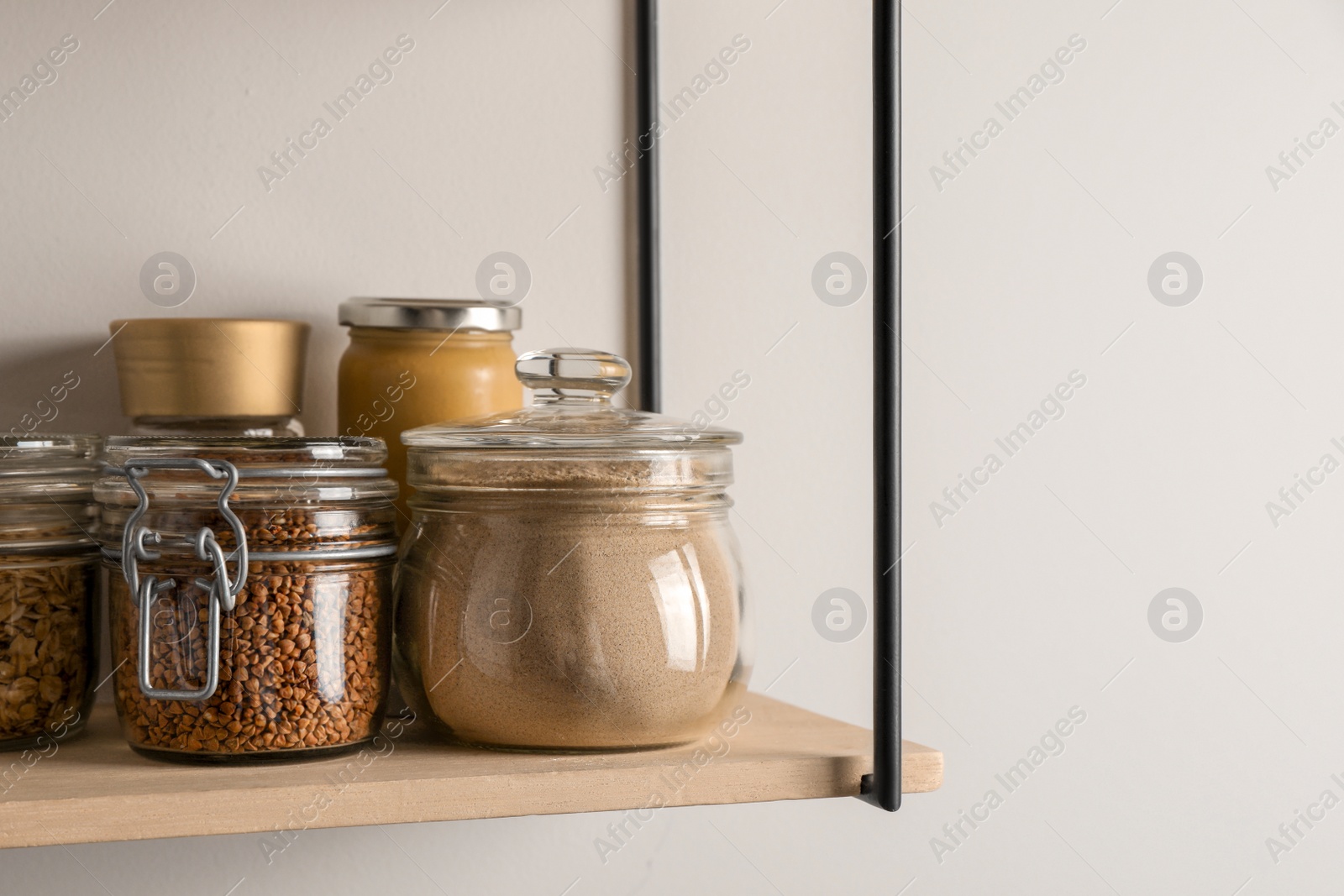 Photo of Flour and buckwheat in glass jars on shelf