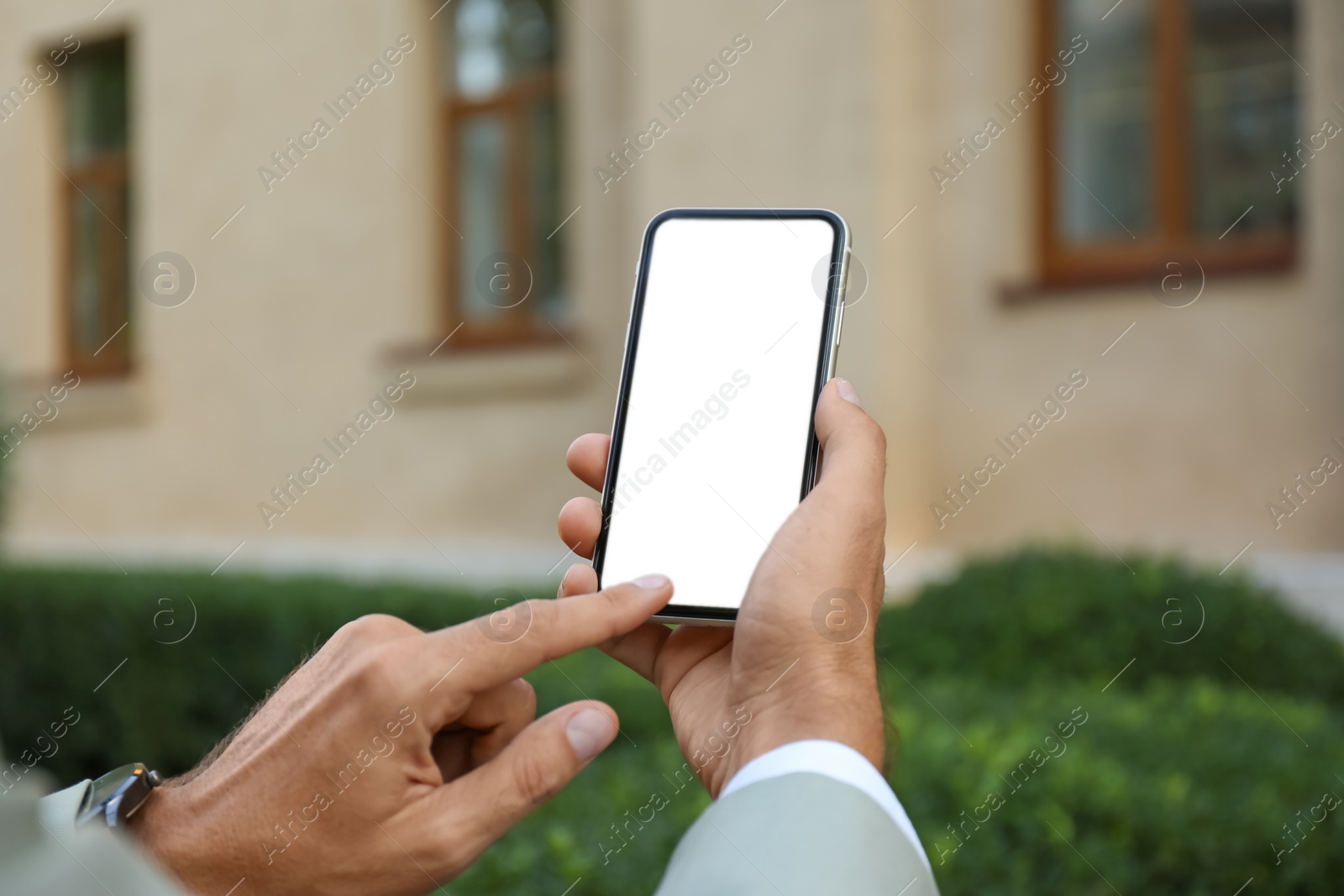 Photo of Man using modern mobile phone outdoors, closeup