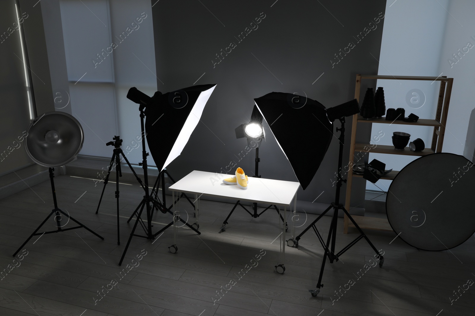 Photo of Professional photography equipment prepared for shooting stylish shoes in studio