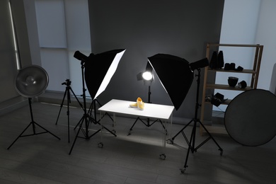 Photo of Professional photography equipment prepared for shooting stylish shoes in studio