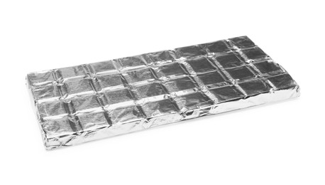 Photo of Tasty chocolate bar wrapped in foil isolated on white