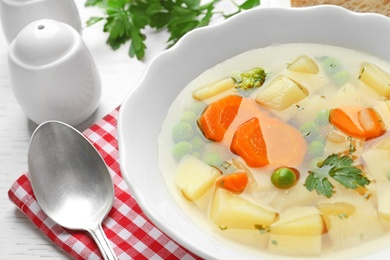 Bowl of fresh homemade vegetable soup served on table, closeup