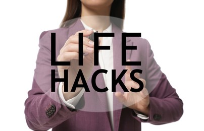 Image of Woman writing words Life Hacks on glass board against white background, closeup