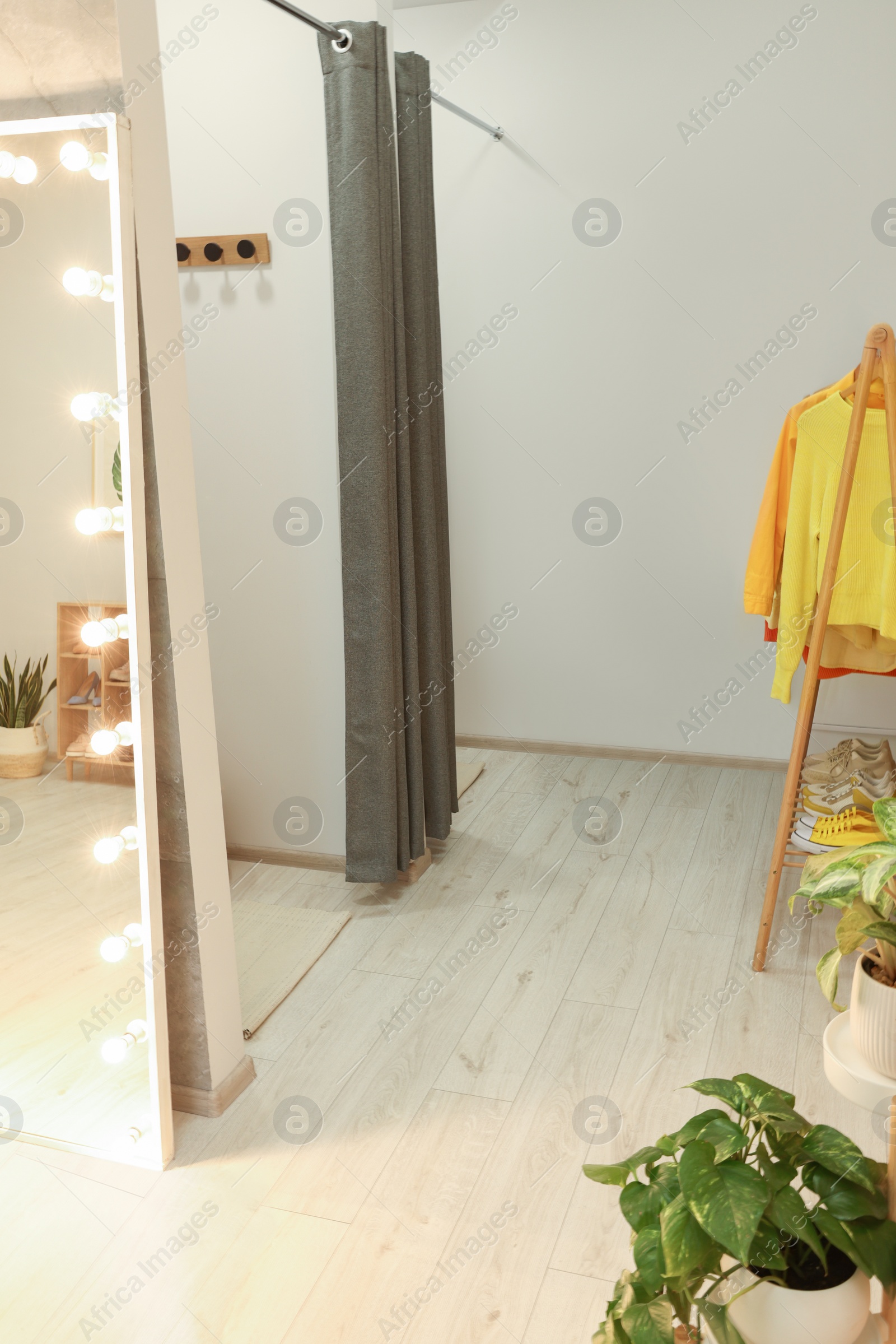 Photo of Dressing room in fashion store. Stylish design