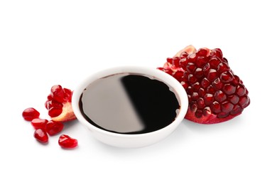 Photo of Bowl of pomegranate sauce and fresh ripe fruit on white background