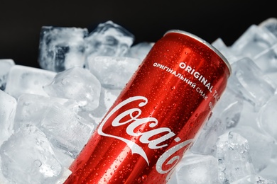 Photo of MYKOLAIV, UKRAINE - NOVEMBER 15, 2018: Coca Cola can on ice cubes against black background