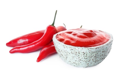 Photo of Bowl with red sauce and fresh chili peppers isolated on white