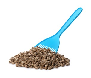 Photo of Light blue plastic scoop and cat litter isolated on white