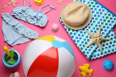 Photo of Beach ball and sand toys on pink background