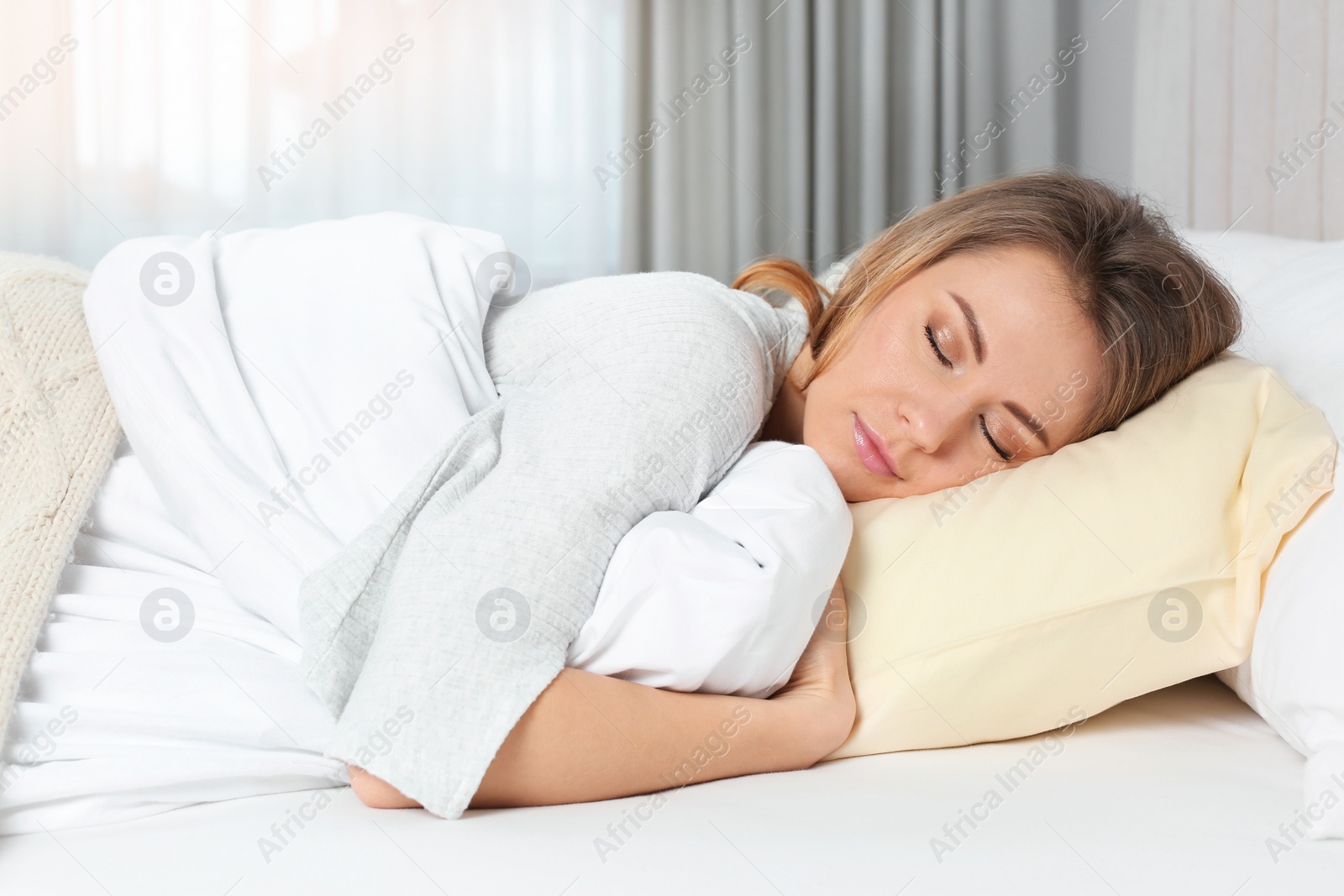 Photo of Beautiful woman sleeping in bed at home