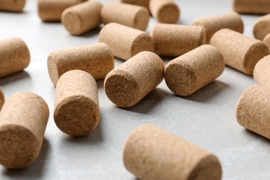 Photo of Wine bottle corks on light grey marble table, closeup
