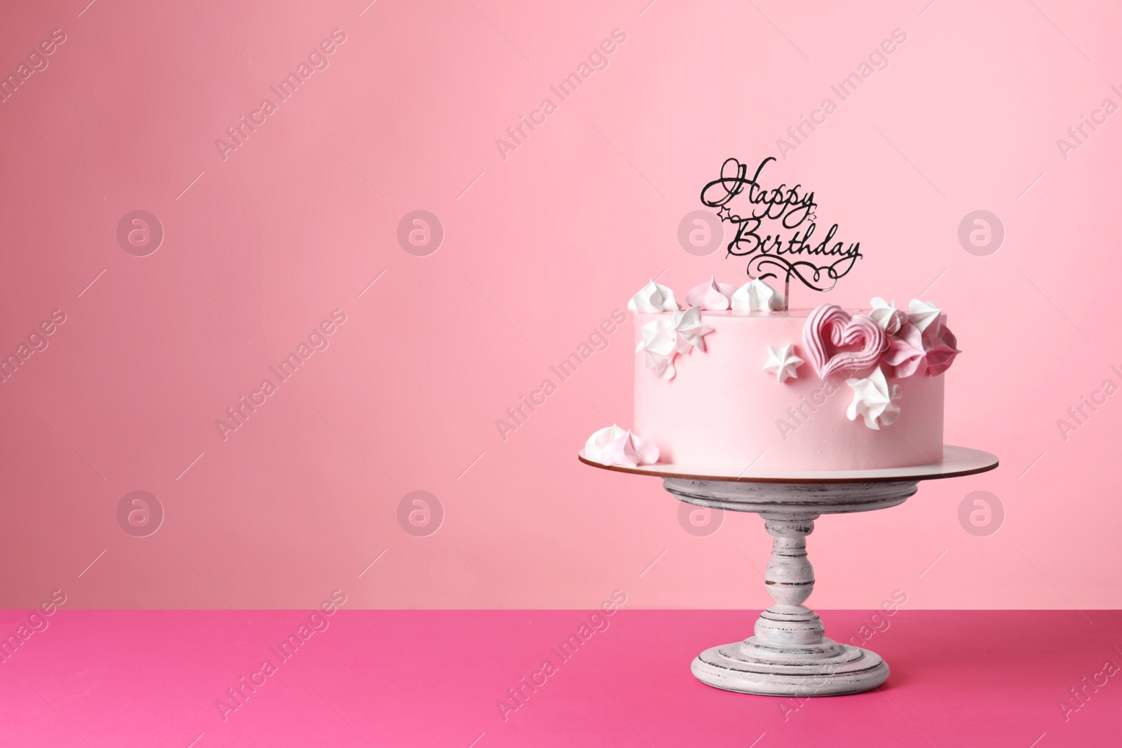 Photo of Beautifully decorated birthday cake on pink background, space for text
