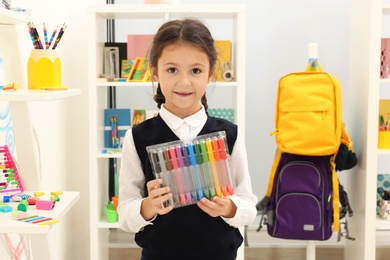 Photo of Cute child choosing school stationery in store