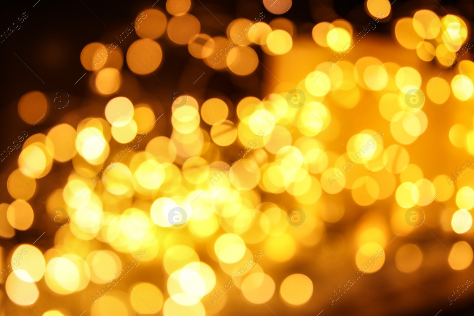 Photo of Gold glitter with bokeh effect on dark background