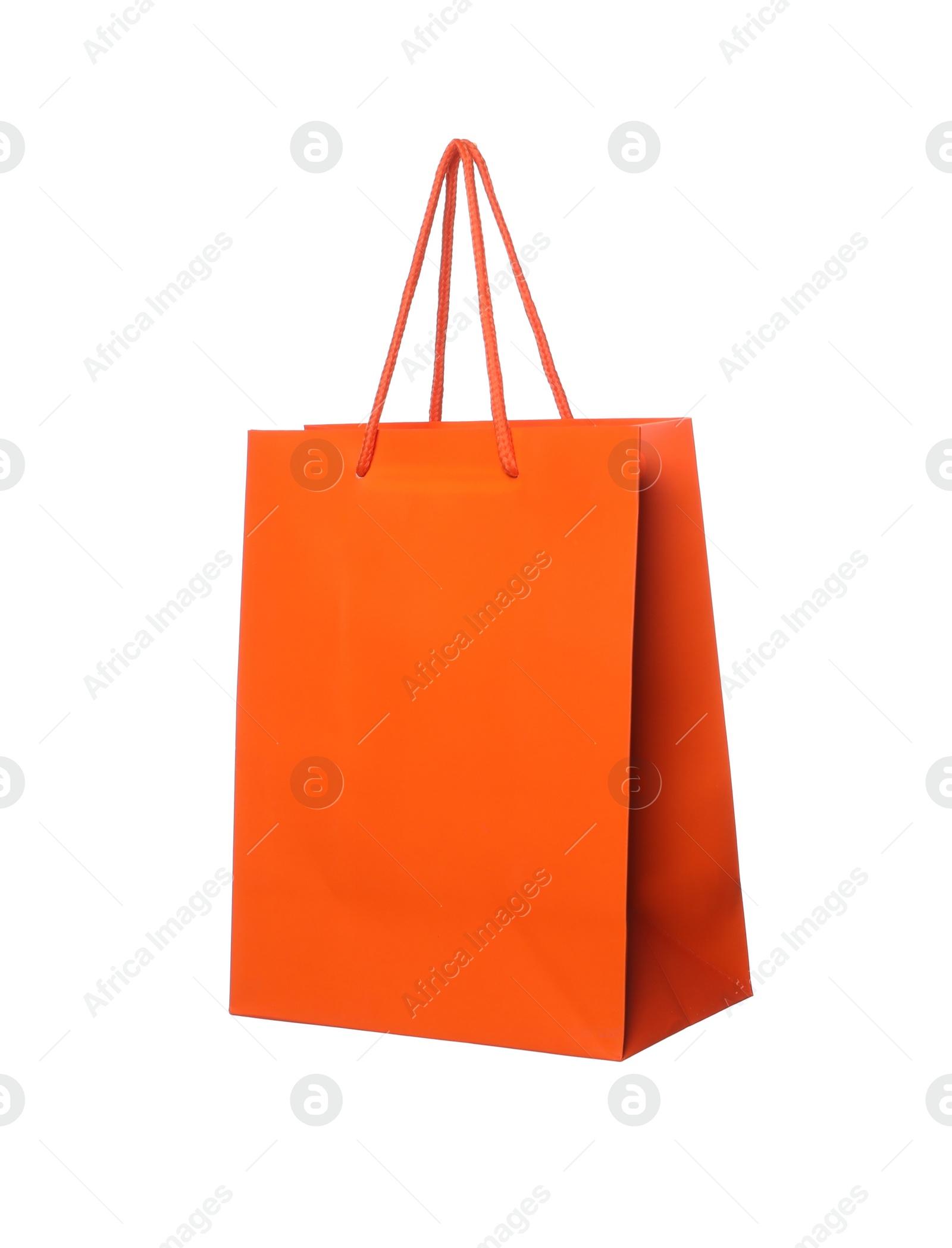 Photo of One orange shopping bag isolated on white