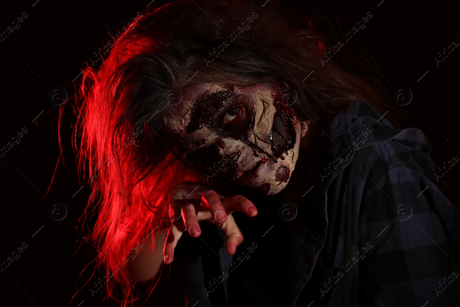 Photo of Scary zombie on dark background. Halloween monster