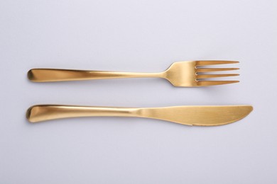 Photo of Stylish cutlery on grey table, top view