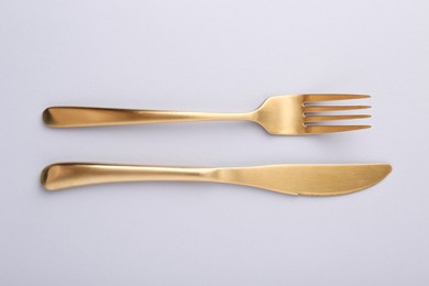 Stylish cutlery on grey table, top view