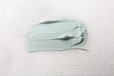 Photo of Samplelight green paint on white canvas