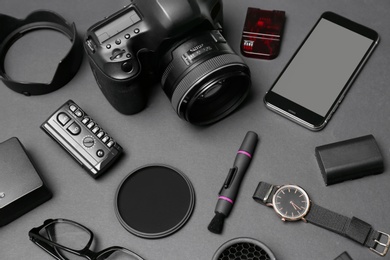 Photo of Composition with equipment for professional photographer on dark background