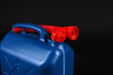 Photo of New blue plastic canister on black background, closeup