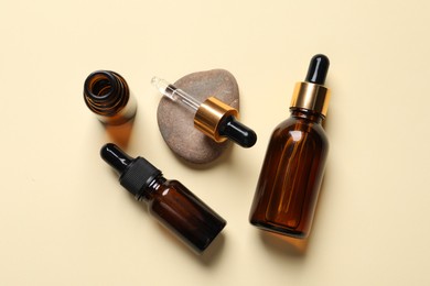 Flat lay composition with face serums on beige background