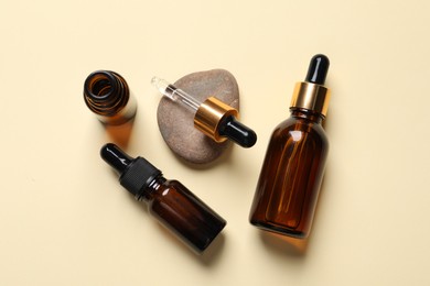 Photo of Flat lay composition with face serums on beige background