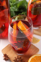 Photo of Delicious punch drink and ingredients on white table