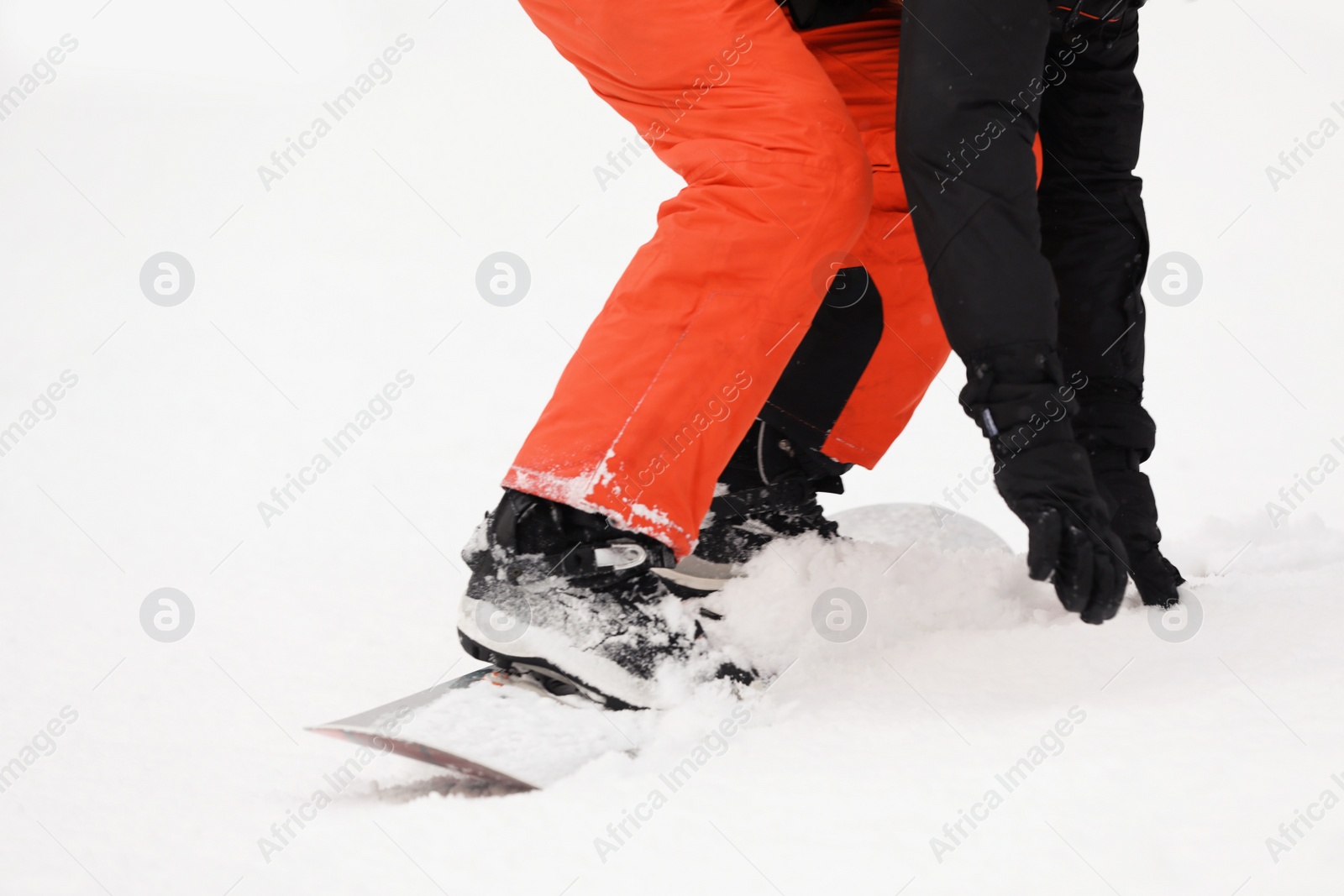 Photo of Snowboarder on slope at resort, closeup. Winter vacation