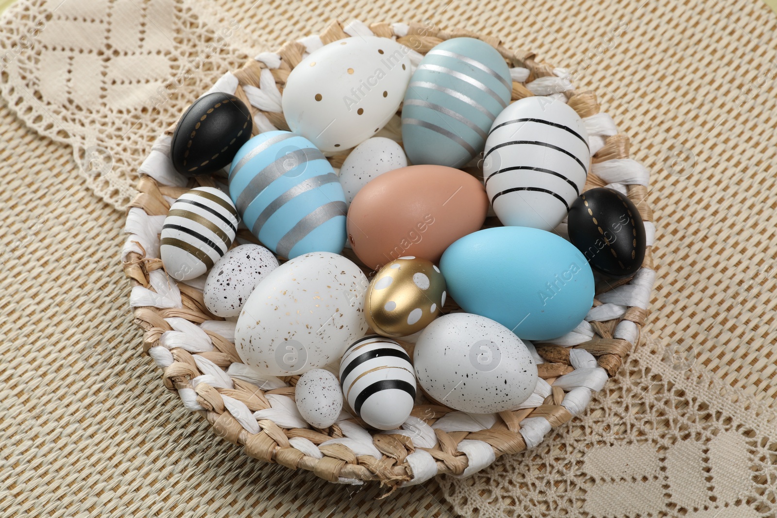 Photo of Many beautifully decorated Easter eggs on table