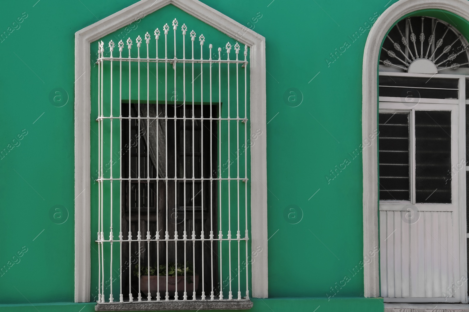 Photo of Exterior of green building with window and door