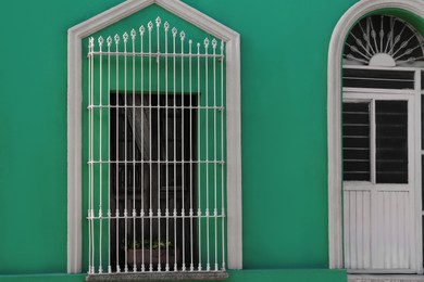 Exterior of green building with window and door