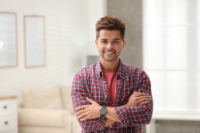 Portrait of handsome young man in room