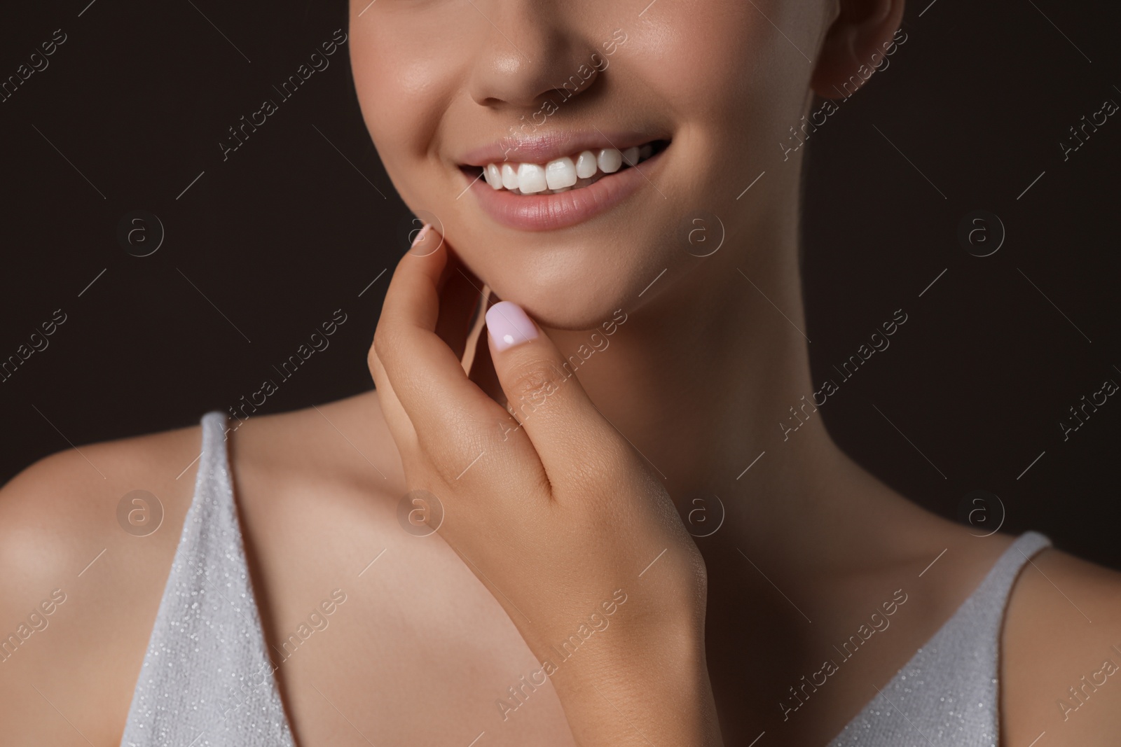 Photo of Girl on brown background, closeup. Beautiful face with perfect smooth skin