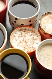 Photo of Many cups of different coffees on table, closeup