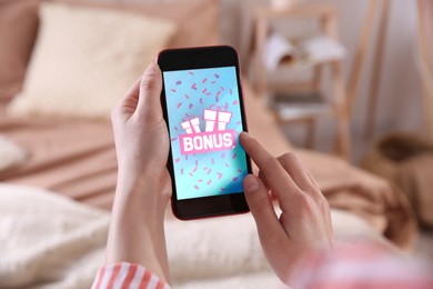 Image of Bonus gaining. Woman using smartphone indoors, closeup. Illustration of gift boxes, word and falling confetti on device screen