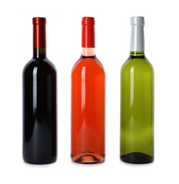 Photo of Bottles of expensive wines on white background